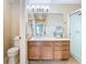 Bright bathroom features a wood vanity, a large mirror, and a glass-enclosed shower at 1757 Sunset Palm Dr, Apopka, FL 32712