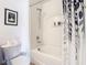 Clean bathroom with a shower and tub showcasing neutral colors and practical fixtures at 1757 Sunset Palm Dr, Apopka, FL 32712