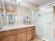 Bathroom features a glass shower, vanity with storage, and a large mirror at 1757 Sunset Palm Dr, Apopka, FL 32712