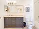 Updated bathroom vanity, toilet, and mirror, offering modern comfort and style at 1757 Sunset Palm Dr, Apopka, FL 32712