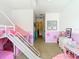 This bright bedroom showcases a bunk bed, a slide, and decorative touches at 1757 Sunset Palm Dr, Apopka, FL 32712