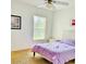 Bright bedroom featuring a cozy bed, ceiling fan, and natural light streaming through the window at 1757 Sunset Palm Dr, Apopka, FL 32712