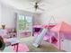 Charming bedroom with bunkbeds, slide, and playful decor at 1757 Sunset Palm Dr, Apopka, FL 32712