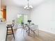 Bright dining area with a modern table and chairs, sliding door and barstool seating at 1757 Sunset Palm Dr, Apopka, FL 32712