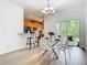Bright dining room with a modern chandelier, table set, and kitchen bar at 1757 Sunset Palm Dr, Apopka, FL 32712