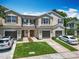 Well-manicured townhomes featuring attached garages and landscaped front yards providing curb appeal at 1757 Sunset Palm Dr, Apopka, FL 32712