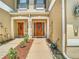 Charming front entrance with double doors and manicured landscaping at 1757 Sunset Palm Dr, Apopka, FL 32712