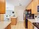 Open kitchen layout, featuring modern appliances and tiled flooring at 1757 Sunset Palm Dr, Apopka, FL 32712