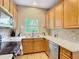 Well-lit kitchen featuring stainless steel appliances and light wood cabinets at 1757 Sunset Palm Dr, Apopka, FL 32712