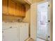 Practical laundry area with washer, dryer, and cabinetry for efficient home management at 1757 Sunset Palm Dr, Apopka, FL 32712