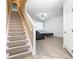 Bright living room with wood floors, comfortable seating, and adjacent stairs to second level at 1757 Sunset Palm Dr, Apopka, FL 32712