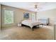 Neutral bedroom with a ceiling fan, two windows, and space for a bed and baby's crib at 1757 Sunset Palm Dr, Apopka, FL 32712
