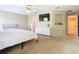Bedroom with ceiling fan, white dresser, and a view of the en-suite bath and walk-in closet at 1757 Sunset Palm Dr, Apopka, FL 32712