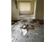 A room with extensive water damage and debris, featuring a sliding glass door at 1822 Williams Manor Ave, Orlando, FL 32811