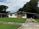 Charming single-story home with a brick entryway and a well-maintained front lawn, offering a welcoming curb appeal at 1822 Williams Manor Ave, Orlando, FL 32811