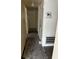 A hallway with damage and disrepair, featuring a thermostat and air vent at 1822 Williams Manor Ave, Orlando, FL 32811