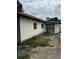 Picture of the home's rear exterior showing its compact yard and white concrete block construction at 1822 Williams Manor Ave, Orlando, FL 32811