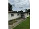 Image of the home's back exterior including a fenced entrance and a compact yard at 1822 Williams Manor Ave, Orlando, FL 32811