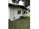 Shows side of home's exterior with an AC unit and hookups with window bars for added security at 1822 Williams Manor Ave, Orlando, FL 32811