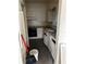 A small, outdated kitchen with old cabinets, appliances and a window at 1822 Williams Manor Ave, Orlando, FL 32811