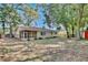View of the back of the home featuring mature trees, a fenced yard, and a screened porch at 2320 Wekiva Ridge Rd, Apopka, FL 32712