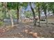 Spacious, treed backyard with a wooden fence providing privacy around the property at 2320 Wekiva Ridge Rd, Apopka, FL 32712