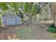 Fenced backyard featuring a storage shed and shade trees providing a private outdoor space at 2320 Wekiva Ridge Rd, Apopka, FL 32712