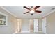 Bedroom featuring a ceiling fan, crown moulding, closet, and bright windows at 2320 Wekiva Ridge Rd, Apopka, FL 32712