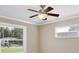 Light bedroom featuring a ceiling fan, crown moulding, and two bright windows at 2320 Wekiva Ridge Rd, Apopka, FL 32712