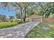 Lovely home with a long driveway and an attached two-car garage with mature trees at 2320 Wekiva Ridge Rd, Apopka, FL 32712