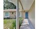Front entrance showcasing a blue front door, stone accents and walkway with garden at 2320 Wekiva Ridge Rd, Apopka, FL 32712