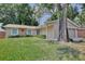 Charming home with a well-manicured lawn, stone accents, and an attached two-car garage at 2320 Wekiva Ridge Rd, Apopka, FL 32712