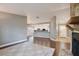 Open-concept living room with fireplace, hardwood floors, and a view into the modern kitchen at 2320 Wekiva Ridge Rd, Apopka, FL 32712