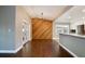 Open living space with wood floors, modern kitchen, and stylish wood accent wall at 2320 Wekiva Ridge Rd, Apopka, FL 32712
