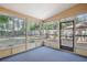 Enclosed sunroom with large windows providing views of the spacious, fenced backyard at 2320 Wekiva Ridge Rd, Apopka, FL 32712