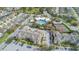 Community aerial view featuring the pool, clubhouse, tennis courts, and surrounding apartment buildings at 2346 Silver Palm Dr, Kissimmee, FL 34747
