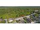 Aerial view highlights a row of townhomes backing onto a dense green forest, marked by a location pin at 2346 Silver Palm Dr, Kissimmee, FL 34747