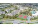 Aerial view of the community featuring multiple apartment buildings and two tennis courts at 2346 Silver Palm Dr, Kissimmee, FL 34747