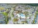 Aerial view of the community, highlighting the pool, clubhouse, and tennis courts amidst lush landscaping at 2346 Silver Palm Dr, Kissimmee, FL 34747