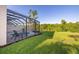 Private screened-in pool and lush green lawn offer a serene outdoor experience at 2346 Silver Palm Dr, Kissimmee, FL 34747