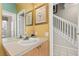 Well-lit bathroom featuring a vanity sink, decorative mirrors, and access to other rooms at 2346 Silver Palm Dr, Kissimmee, FL 34747