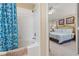 Well-lit bathroom features a shower-tub combo and leads into the Primary bedroom at 2346 Silver Palm Dr, Kissimmee, FL 34747