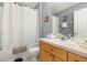 Bathroom with a shower-tub combo, a single sink vanity, and decorative accents at 2346 Silver Palm Dr, Kissimmee, FL 34747