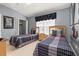 Bright bedroom featuring two beds, closet, and a window with natural light at 2346 Silver Palm Dr, Kissimmee, FL 34747