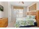 Well-lit bedroom showcasing a cozy bed, window with blinds, and a wooden dresser for storage at 2346 Silver Palm Dr, Kissimmee, FL 34747