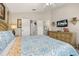 Bedroom featuring a floral patterned bed, ceiling fan, and a view into the bathroom and walk-in closet at 2346 Silver Palm Dr, Kissimmee, FL 34747