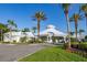 A beautiful clubhouse features white exterior, pillars, tropical foliage, and green lawns at 2346 Silver Palm Dr, Kissimmee, FL 34747
