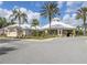 Beautiful clubhouse with palm trees, offering a welcoming entrance and landscaped surroundings at 2346 Silver Palm Dr, Kissimmee, FL 34747