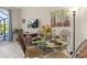Cozy dining area features modern decor, a glass table, and seating for four at 2346 Silver Palm Dr, Kissimmee, FL 34747