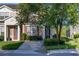 Charming townhome featuring a well-maintained lawn, mature trees, and inviting front entrance at 2346 Silver Palm Dr, Kissimmee, FL 34747